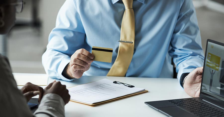Business man in meeting using a credit card