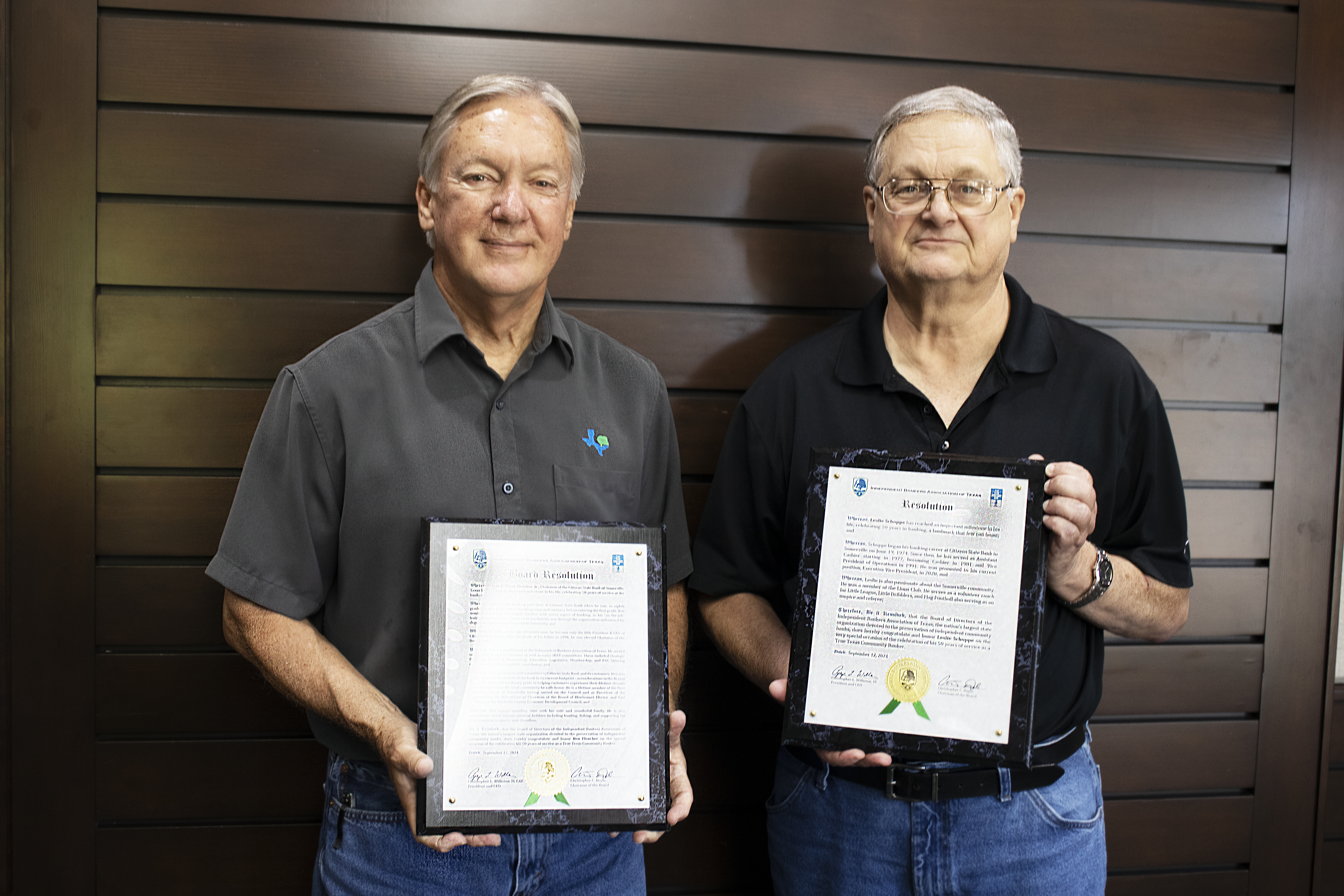 Citizens State Bank board members holding up plaques.
