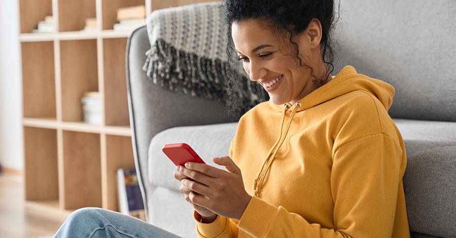 Young lady using her smartphone at home